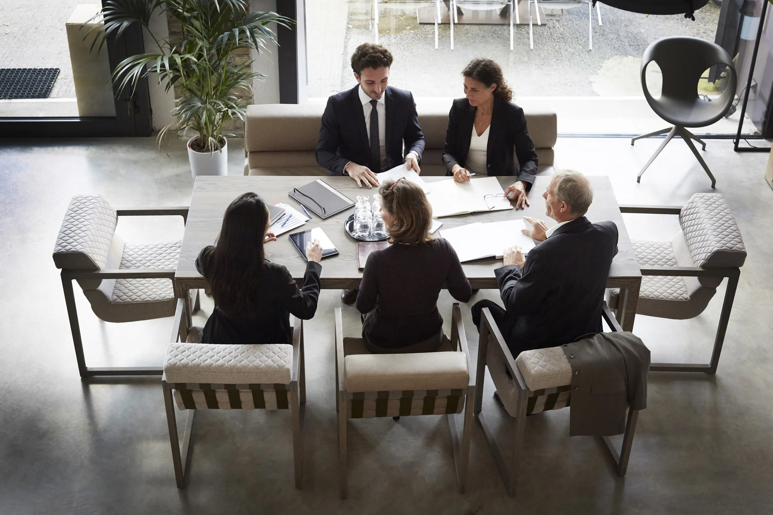 Business team collaborating at a table, sharing ideas and strategies in a professional setting.